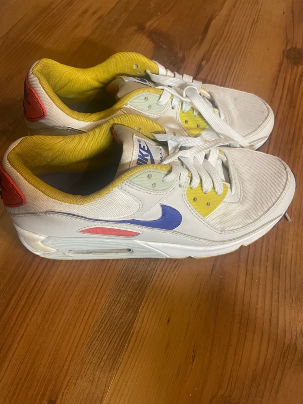 Nike White Sneakers with Yellow Lining, Purple Swoosh & Red Heel Accent